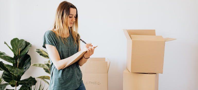 a couple holding moving boxes