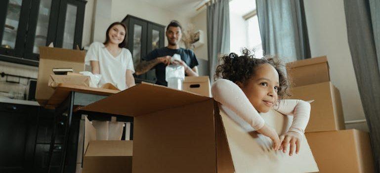 a happy family unpacking in their new home