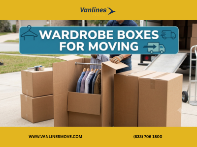 Stack of sturdy wardrobe boxes with hanging clothes inside, ready for moving.